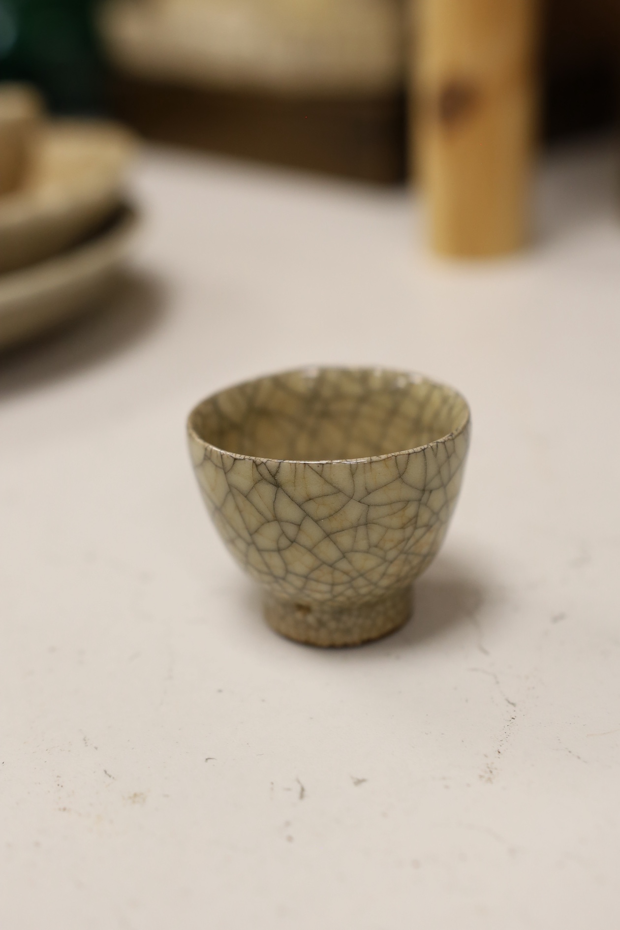 A Chinese crackle glaze chrysanthemum shaped dish, two cups and an underglaze blue dish, 19th century and later, blue dish 21cm diameter (4). Condition - fair